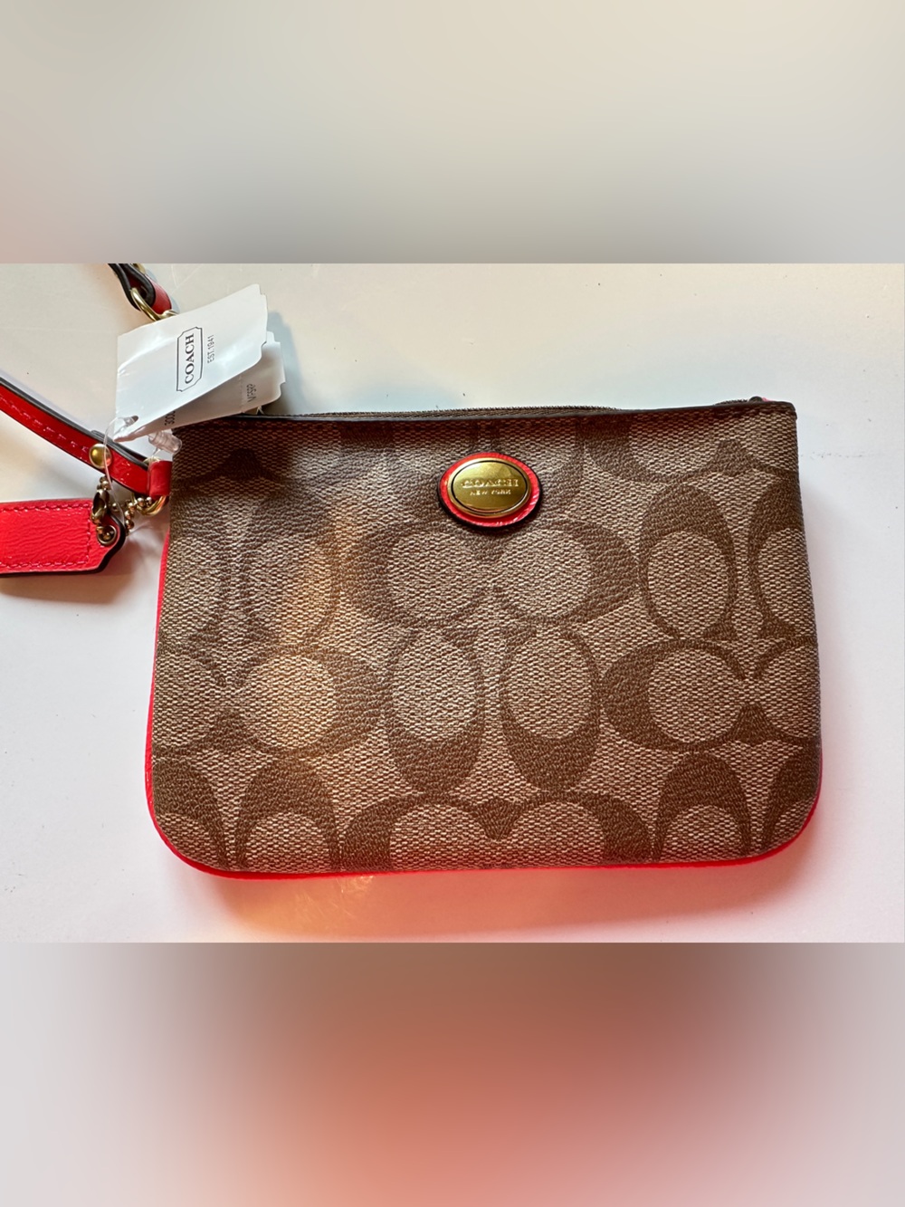 Coach Brown Signature Canvas Wristlet with coral Trim
